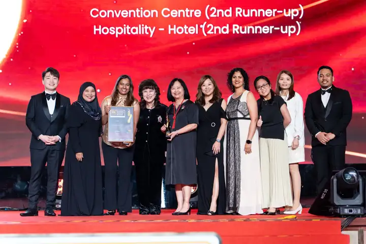 A winning team on stage with its certificate